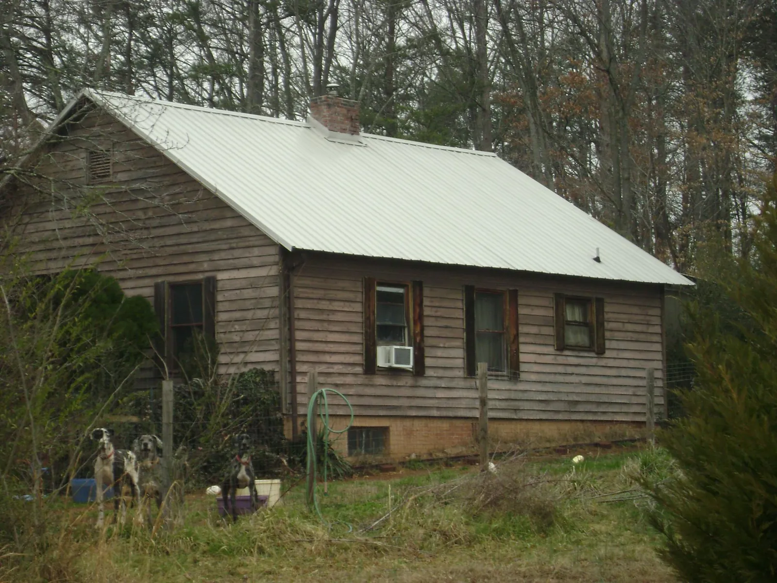 White metal roof on an old wood sided farmhouse, from a Metal Roof Installation job in Seneca